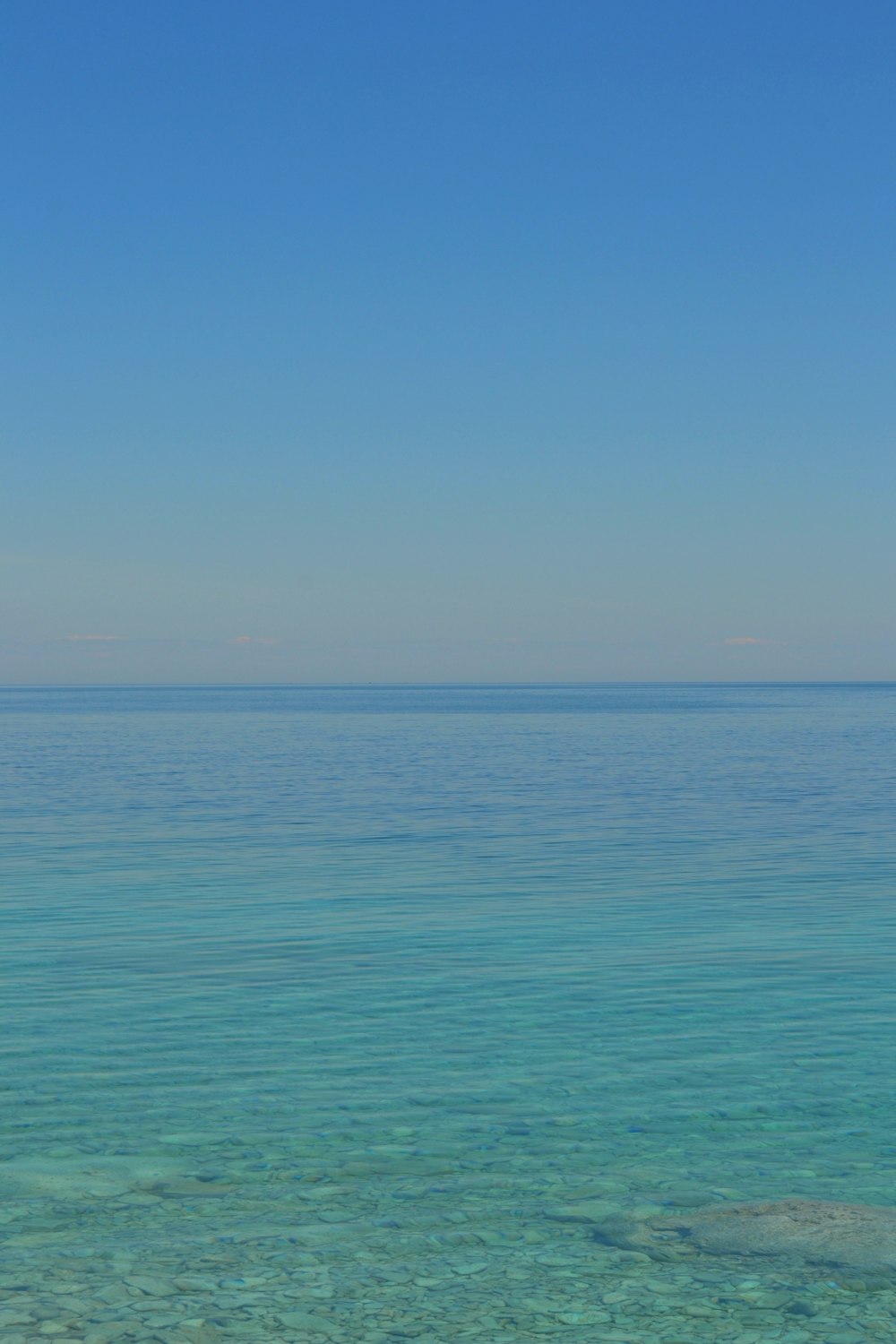 blue ocean under blue sky during daytime