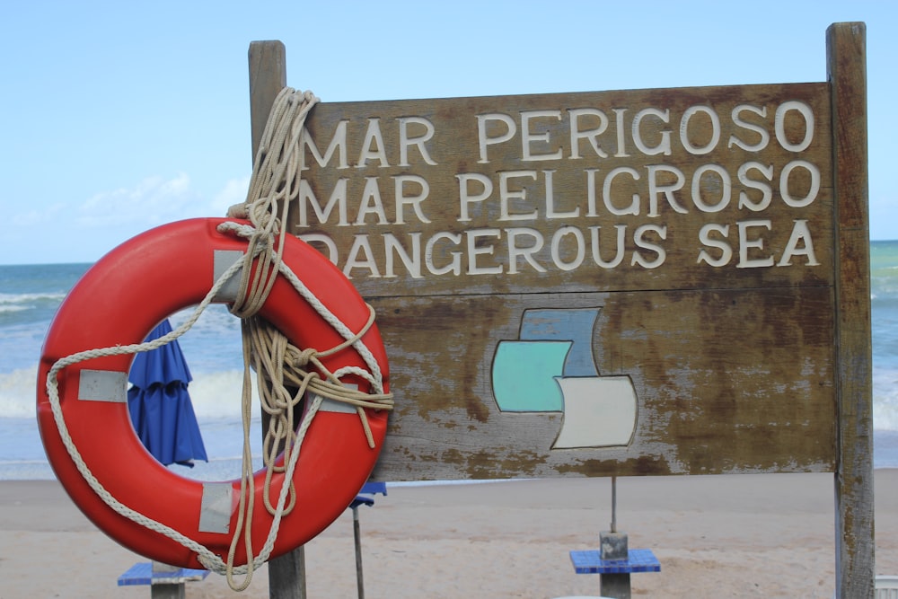 brown wooden beach signage during daytime