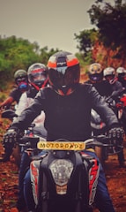 man in black and red motorcycle suit riding on motorcycle