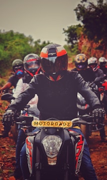 man in black and red motorcycle suit riding on motorcycle