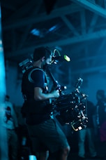 man in black t-shirt playing drum set