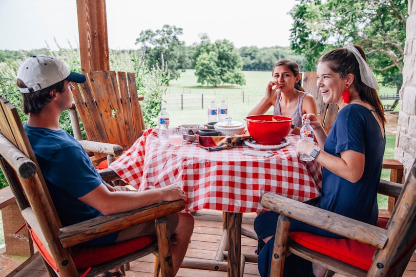 2 women sitting on brown wooden chair eating a THM meal