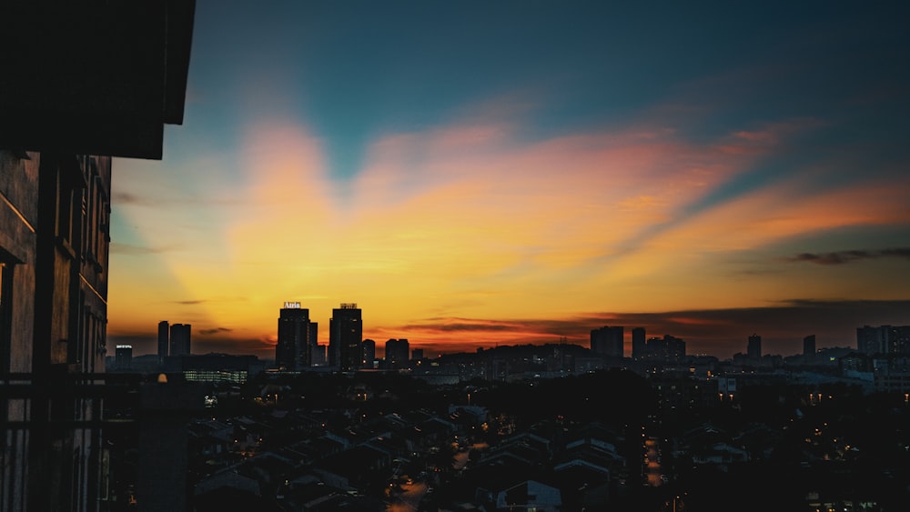 silhouette of city buildings during sunset