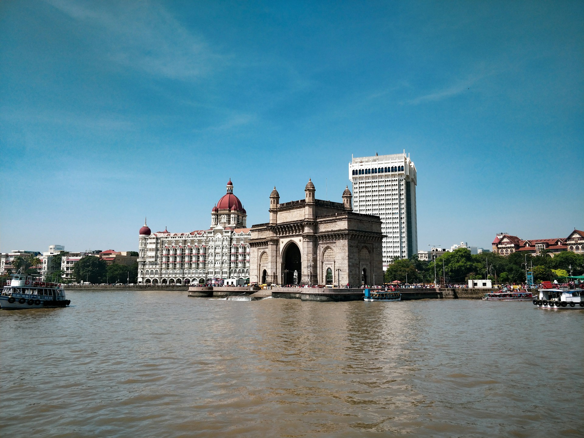 white and brown concrete building near body of water during daytime