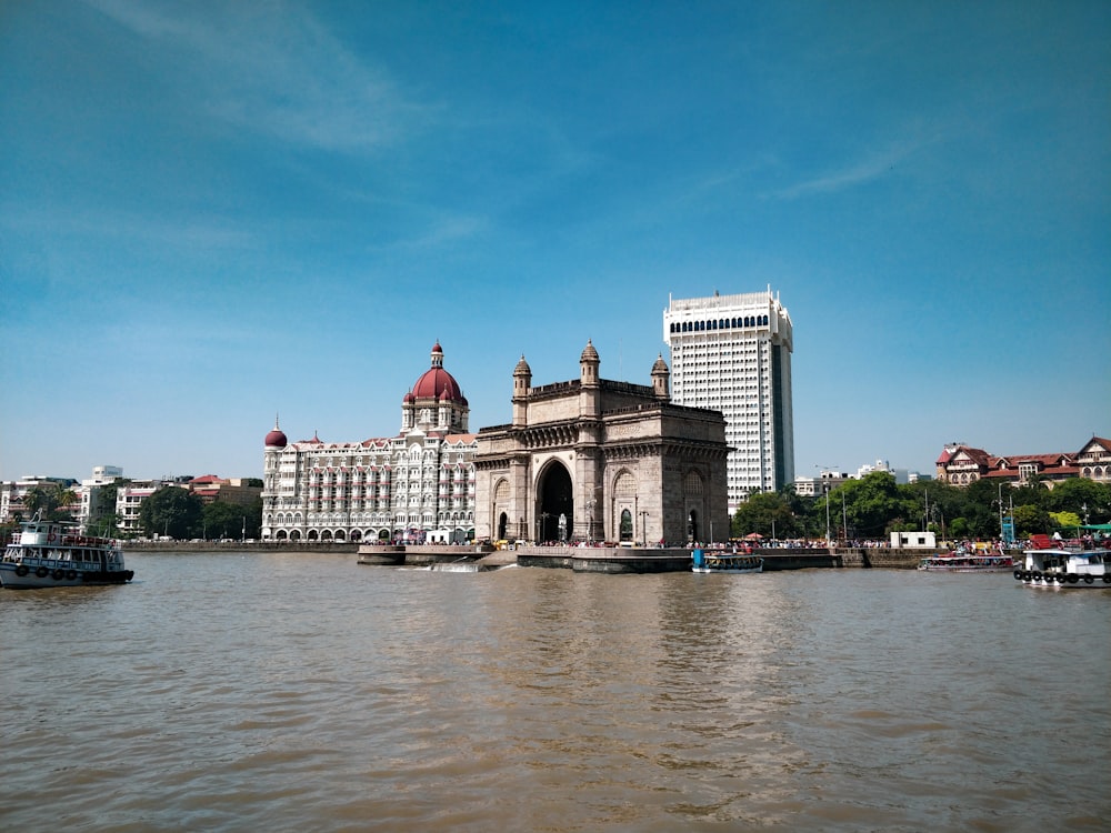 white and brown concrete building near body of water during daytime