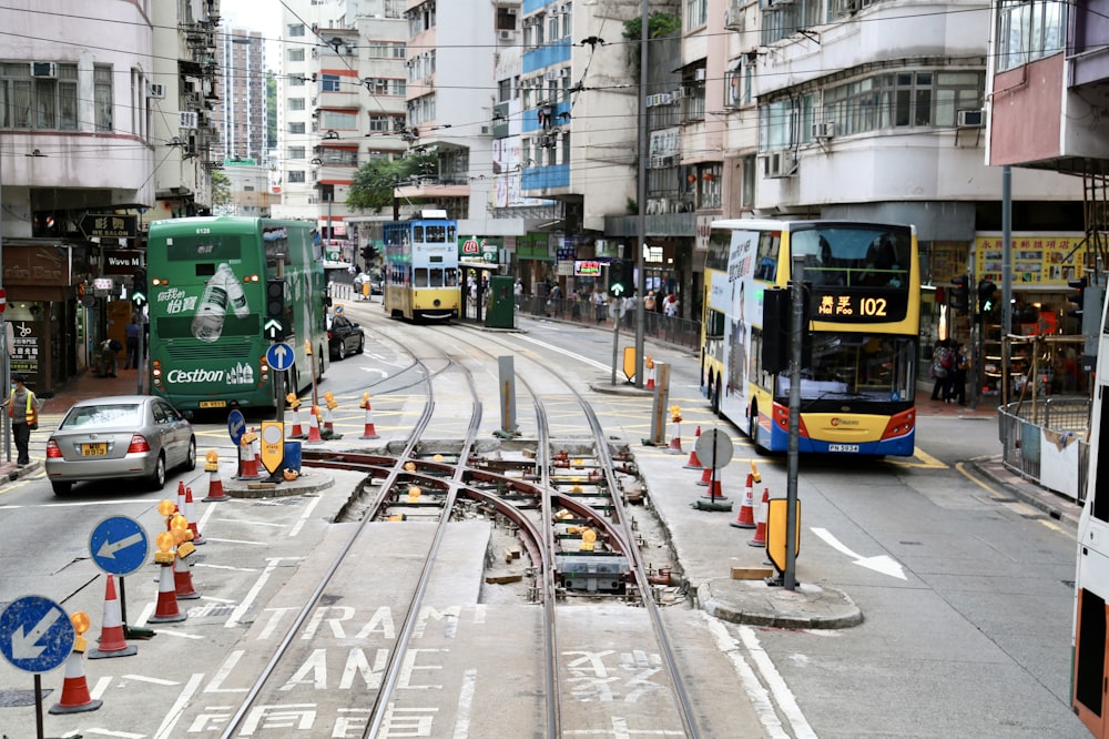 green and yellow bus on road during daytime