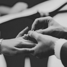 grayscale photo of person wearing ring