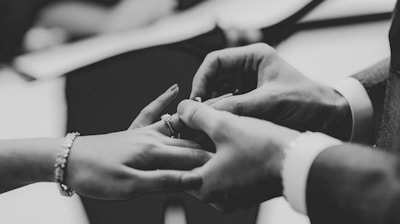 grayscale photo of person wearing ring