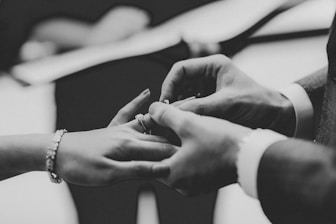 grayscale photo of person wearing ring