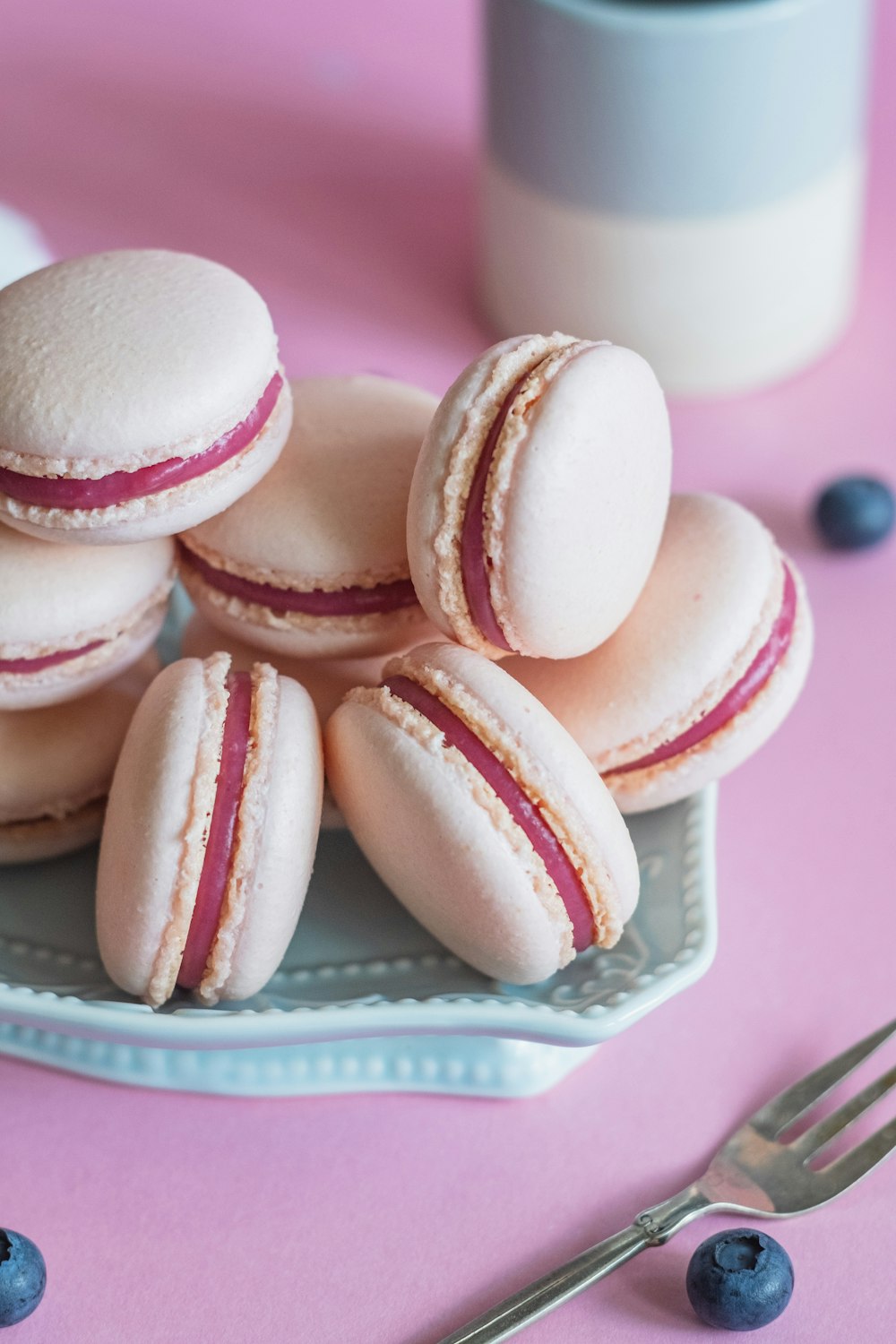 pink and white cupcakes on white and purple ceramic plate