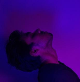 An eye-catching portfolio site for a photographer, with bold purple highlights and dynamic image grids.