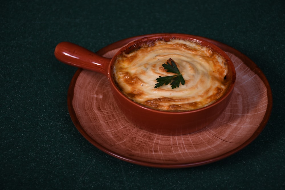 brown soup in red ceramic bowl