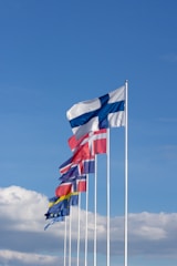 white red and blue striped flag under blue sky during daytime