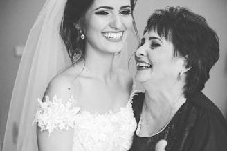 woman in white floral dress beside woman in black and white polka dot shirt