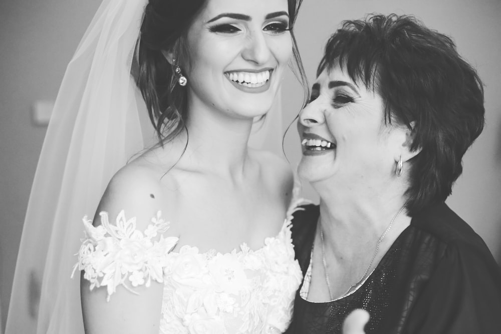 woman in white floral dress beside woman in black and white polka dot shirt