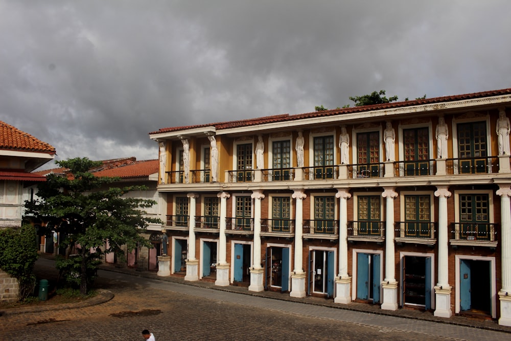 a person walking down a street in front of a building