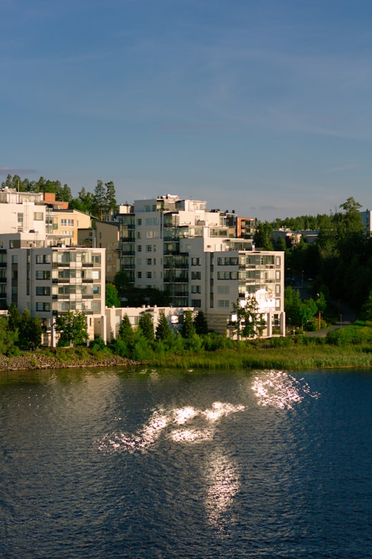 white concrete building near body of water during daytime in Jyväskylä Finland