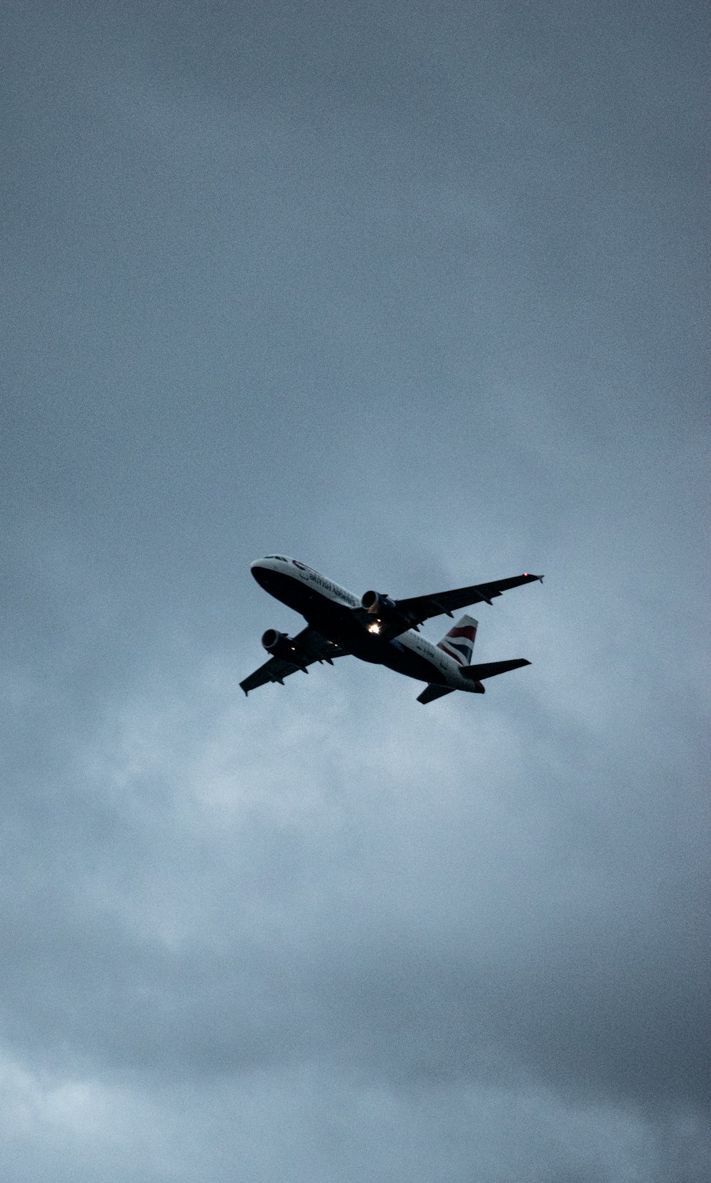 white airplane in mid air during daytime