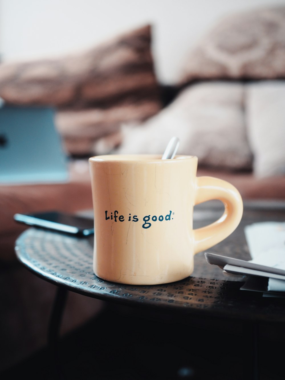 brown ceramic mug on blue and white ceramic plate