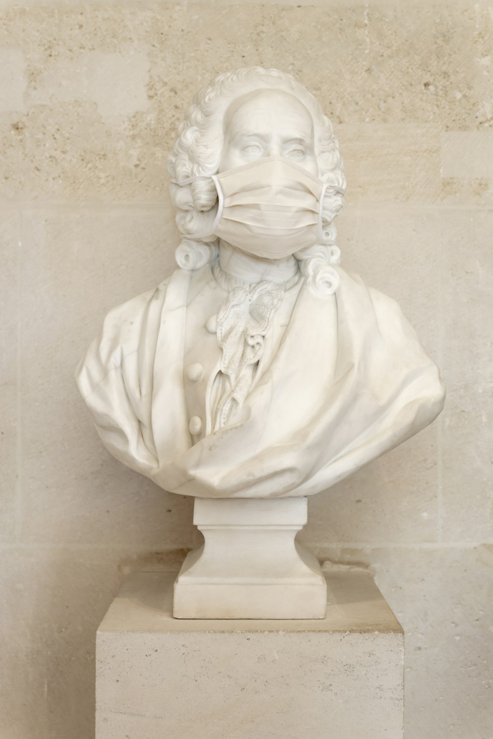 a bust of a man wearing a face mask