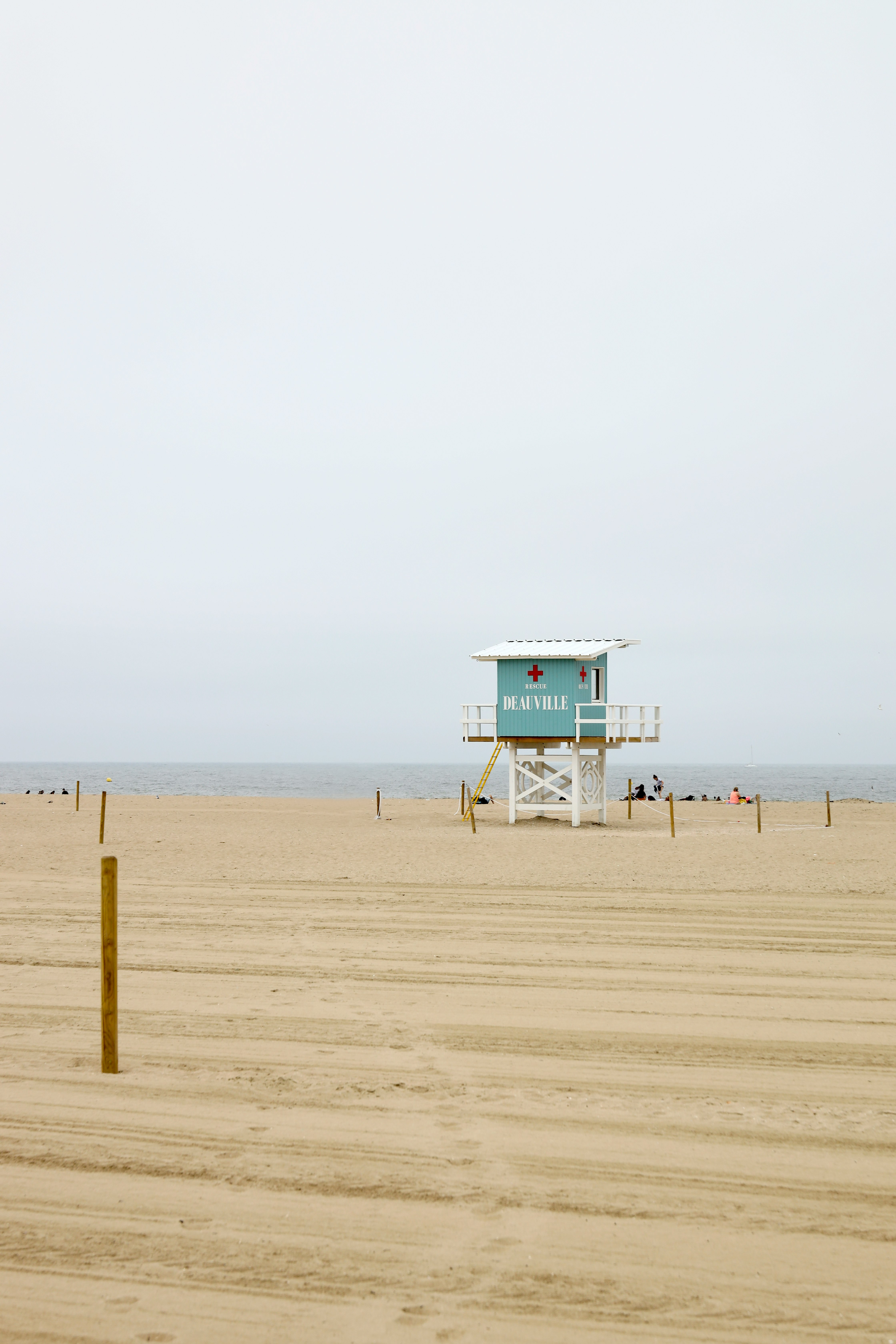 blue and white lifeguard tower on beach