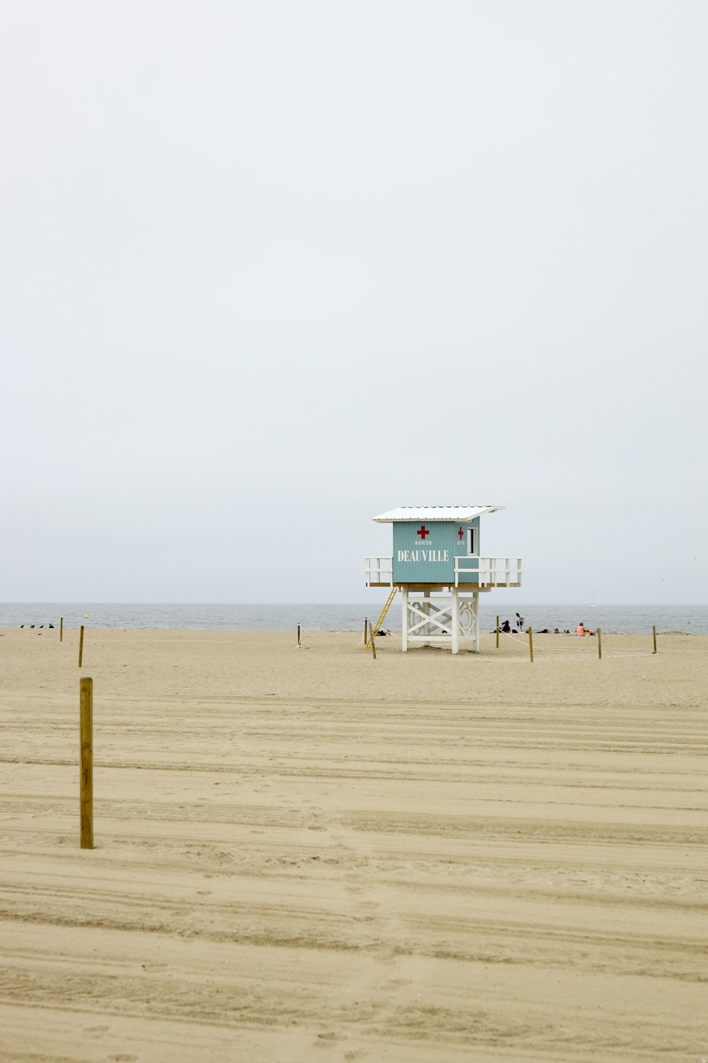 blue and white lifeguard tower on beach