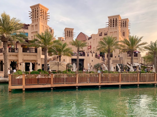 brown concrete building near body of water during daytime in Madinat Jumeirah United Arab Emirates
