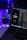 A laptop displaying code in an IDE is next to a mobile phone with an app featuring a green flame icon and the text 'Welcome to Pyro.' A white mug on the desk is illuminated by blue and purple ambient lighting. Potted plant leaves and a colorful LED strip add to the aesthetic setup.