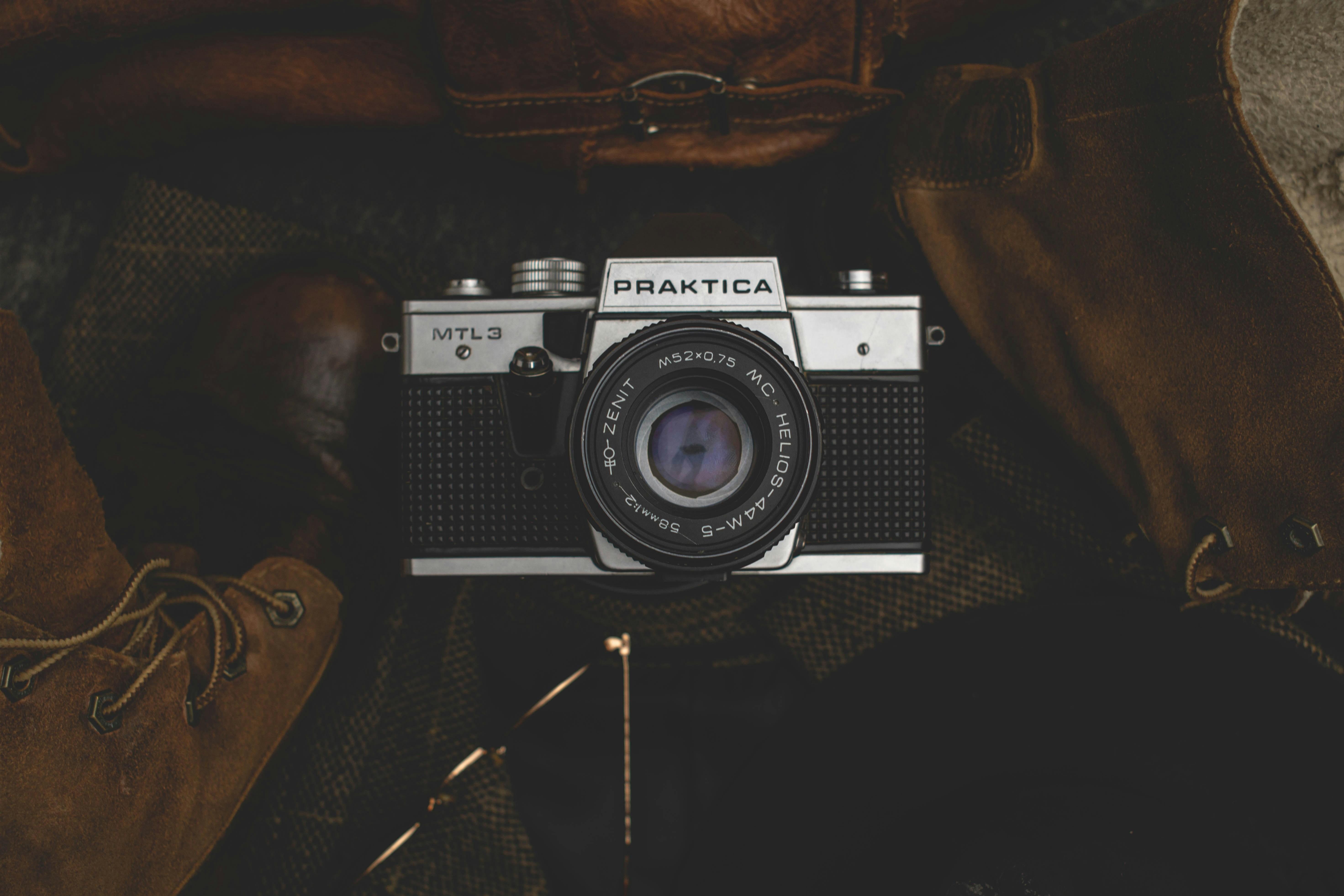 black and silver dslr camera on black textile