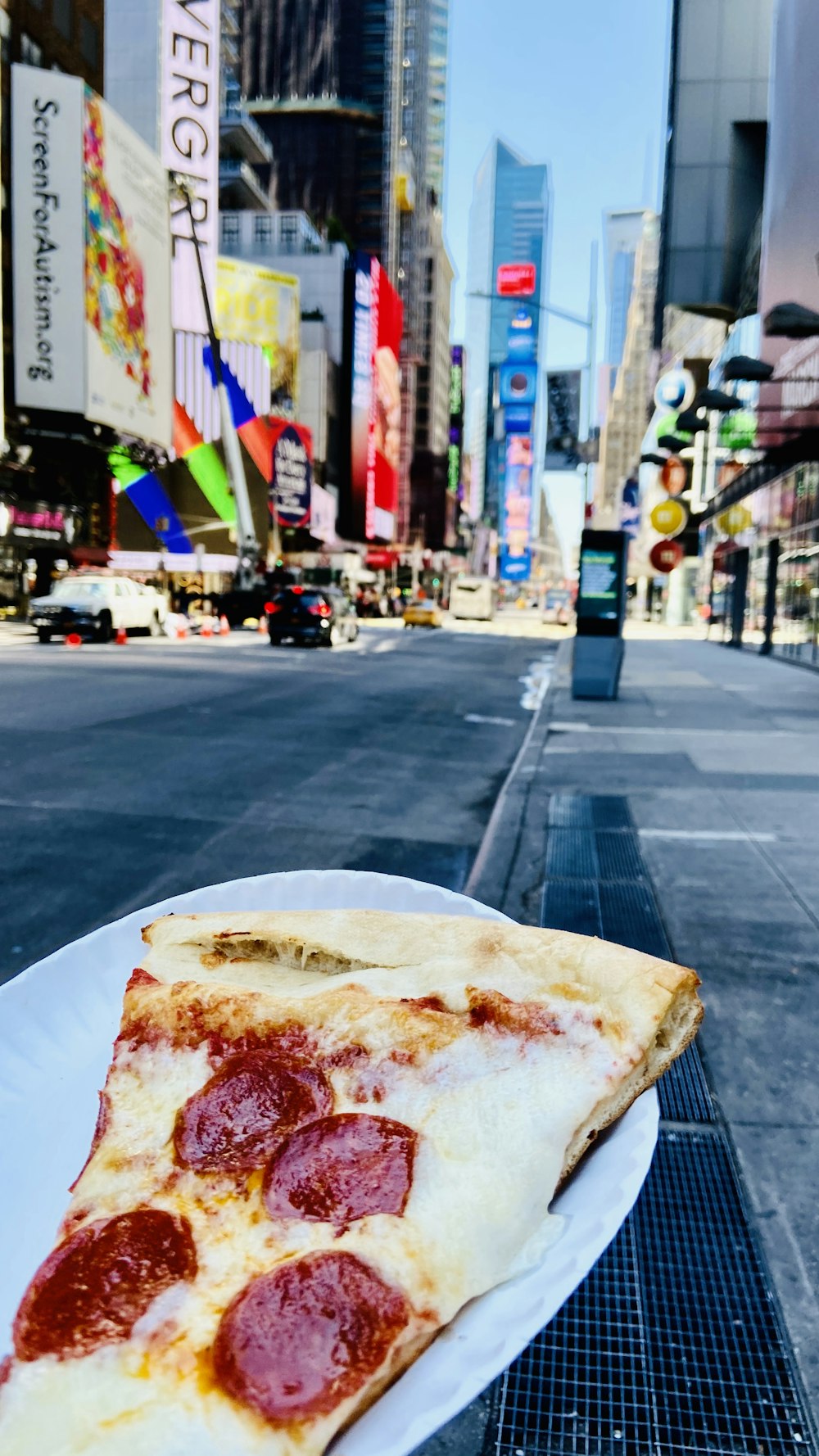 a slice of pepperoni pizza on a white plate