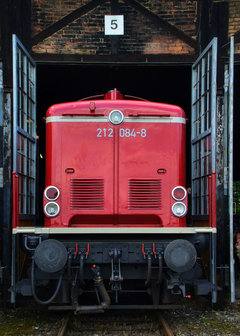 red and black train in a train station