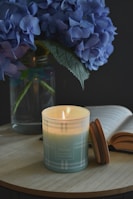 white candle on clear glass holder