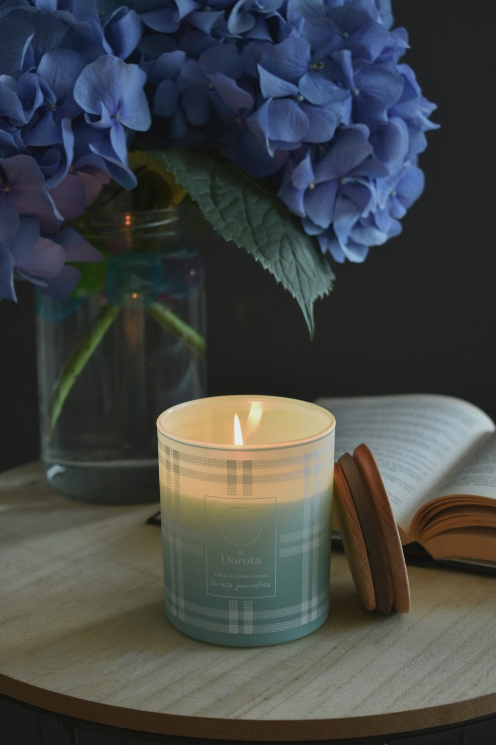 white candle on clear glass holder