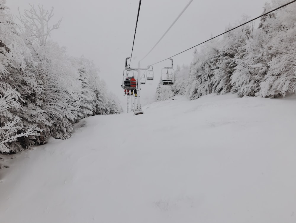 red cable car over snow covered ground