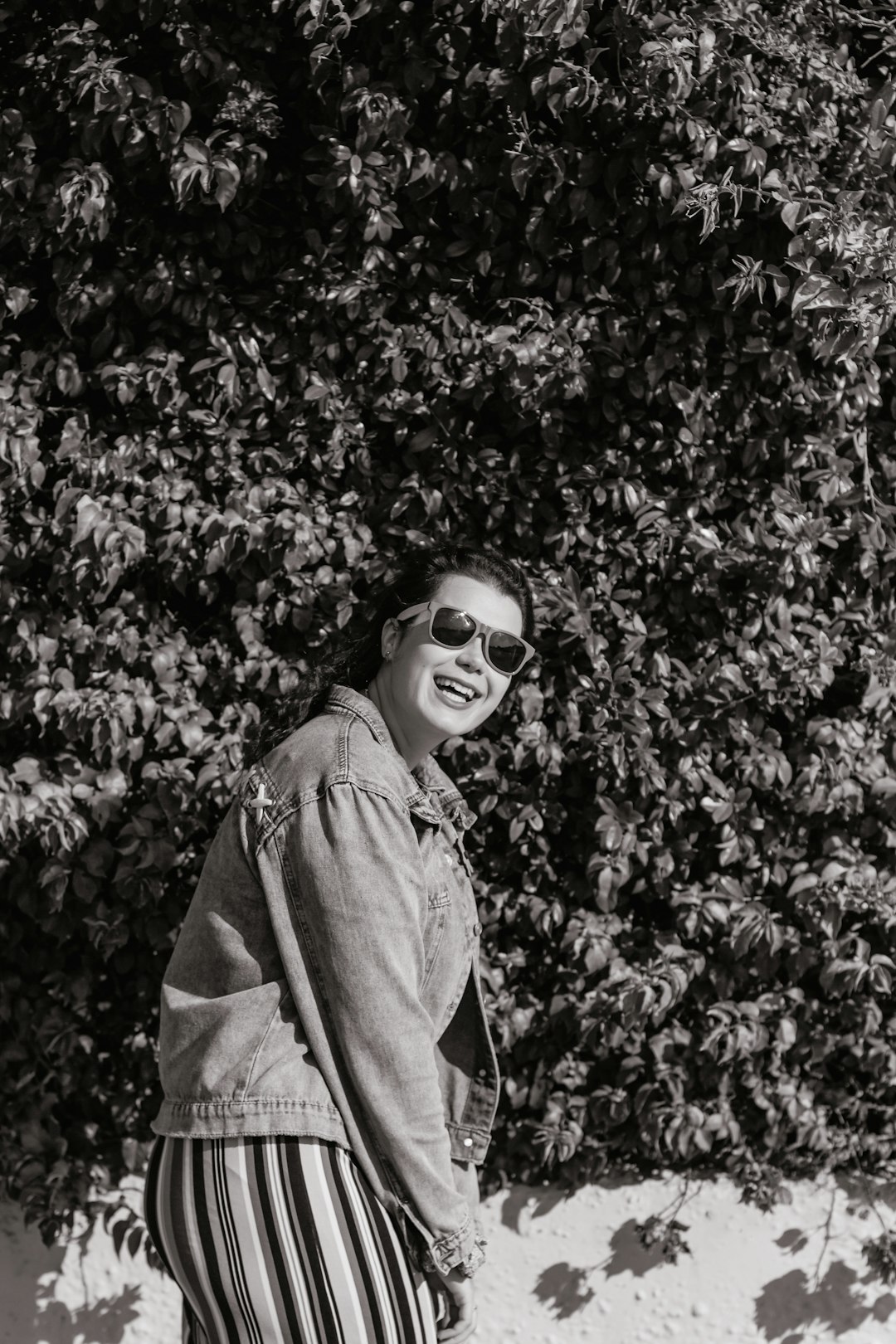 woman in black sunglasses and gray jacket