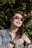 A vibrant image of a person wearing fashionable sunglasses outdoors, enjoying a sunny day.