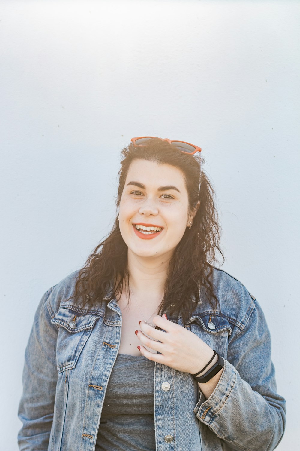 woman in blue denim jacket smiling