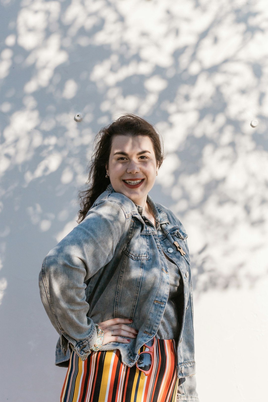 woman in blue denim jacket smiling