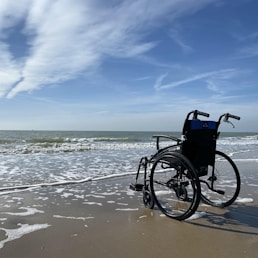 black and gray wheelchair on beach during daytime