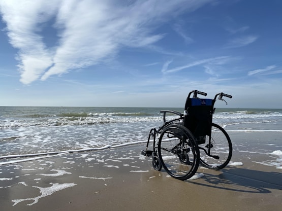 black and gray wheelchair on beach during daytime