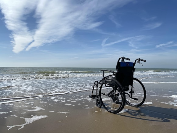 black and gray wheelchair on beach during daytime