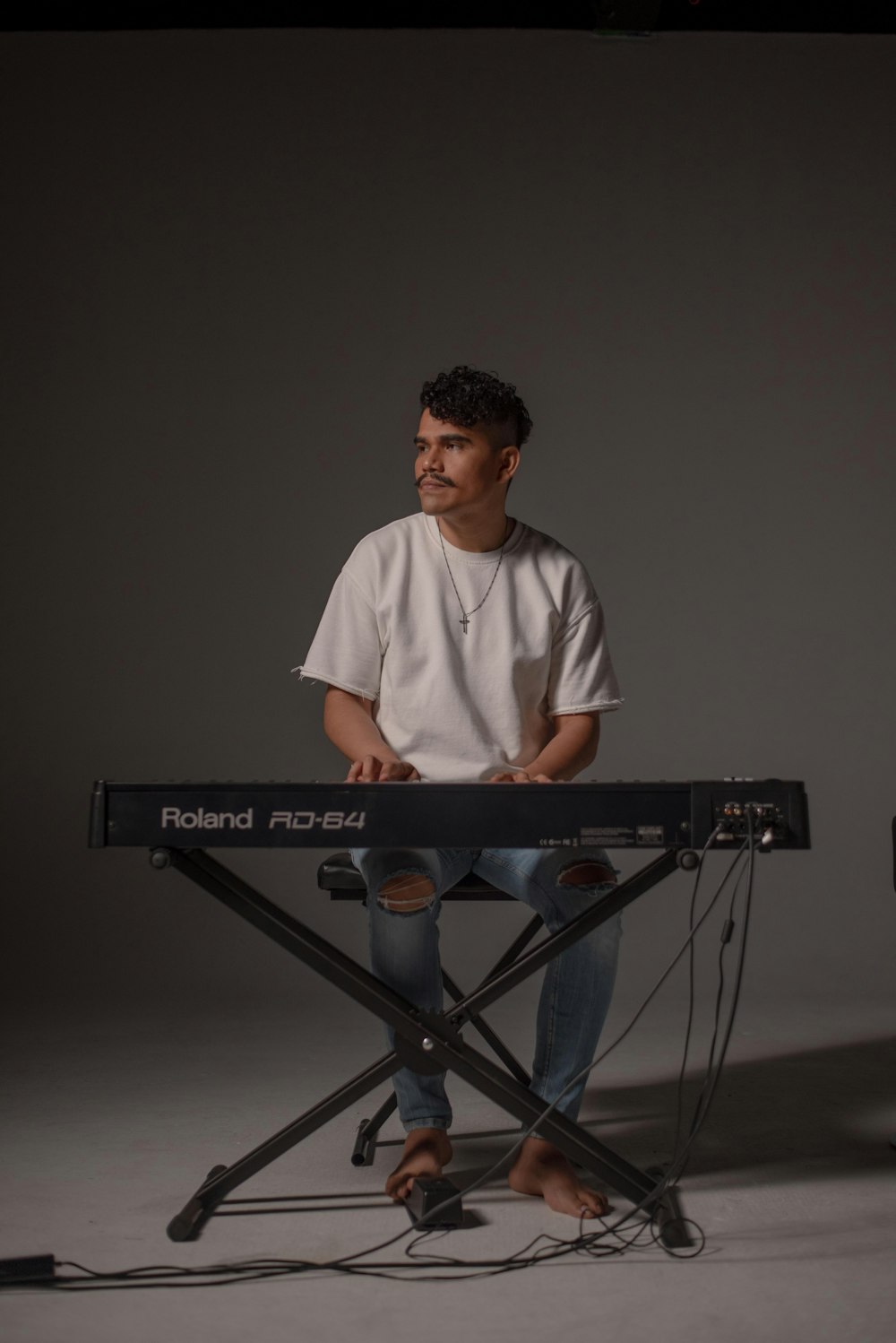 man in white crew neck t-shirt playing electric keyboard