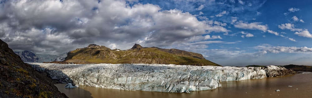 brown and green mountain under white clouds and blue sky during daytime