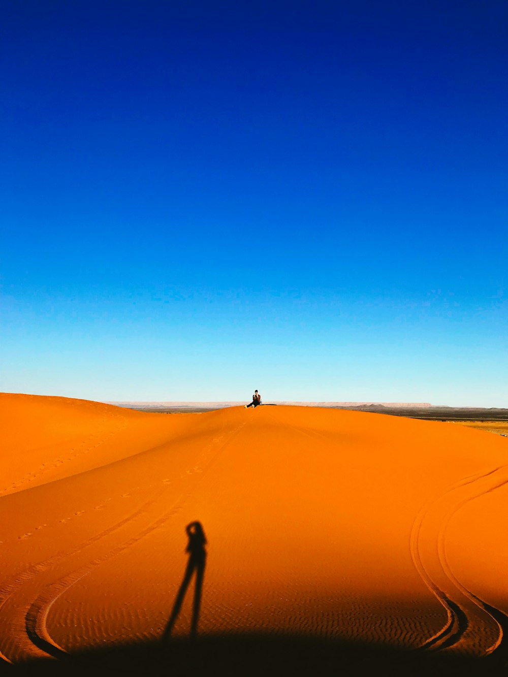 person walking on desert during daytime