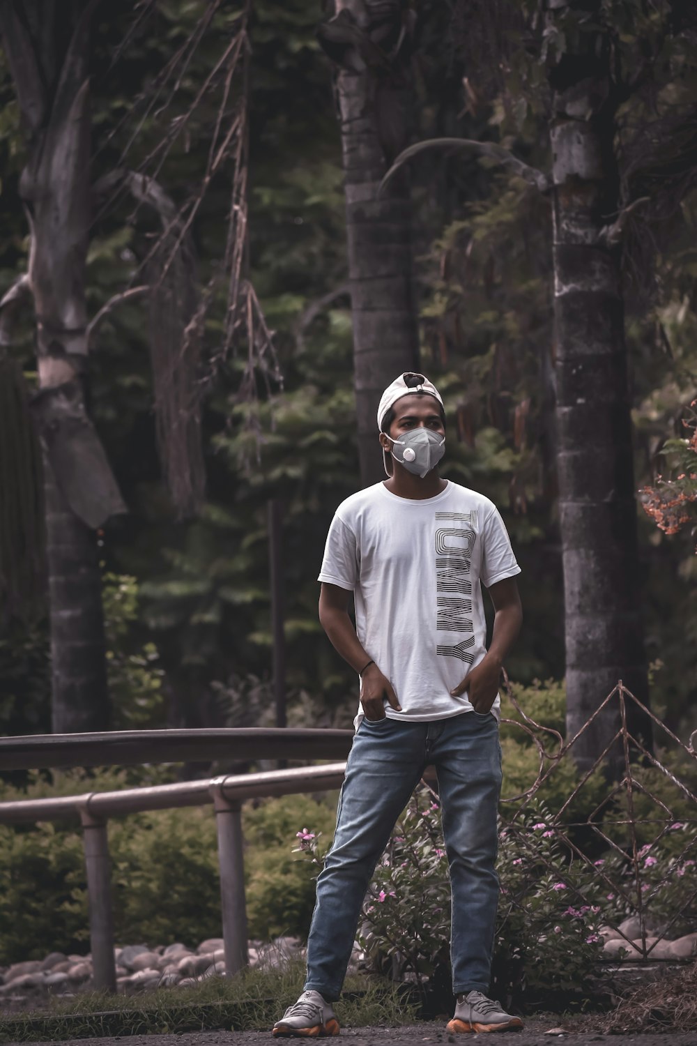 man in white crew neck t-shirt and blue denim jeans wearing white helmet standing on near near near near