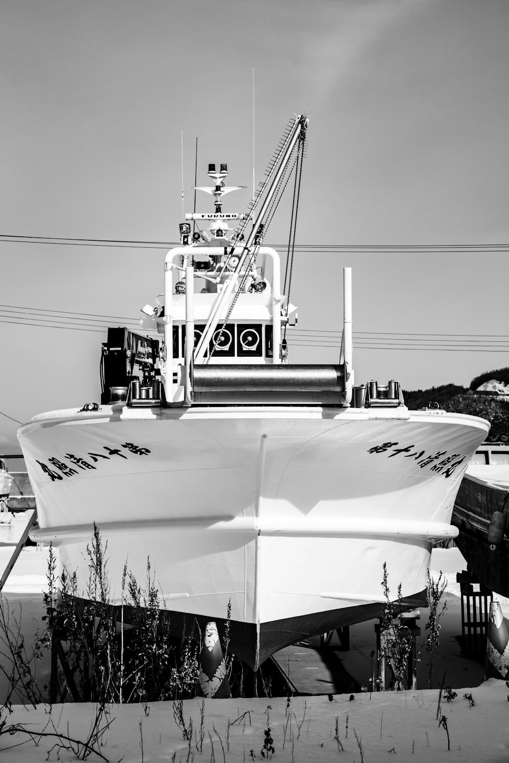 grayscale photo of white boat on body of water