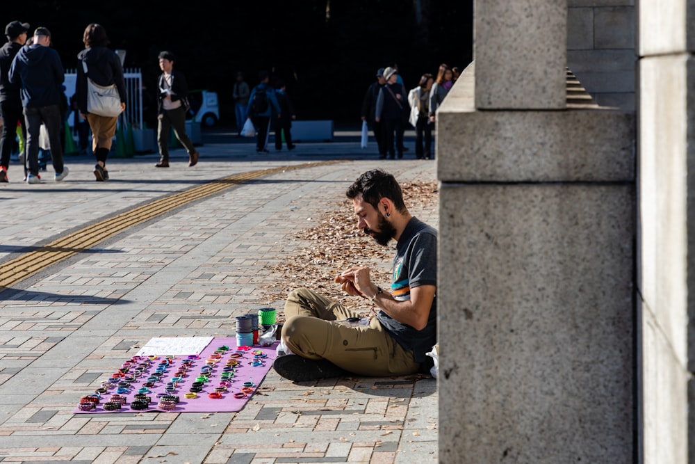 man in black t-shirt sitting on concrete bench