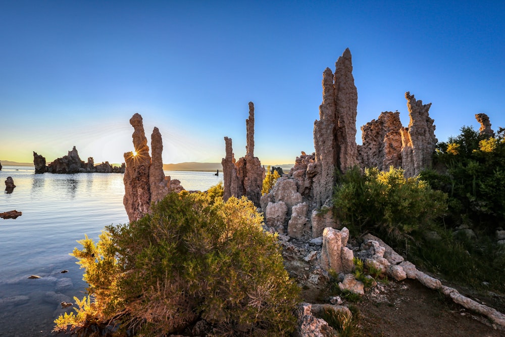 brown rock formation near body of water during daytime