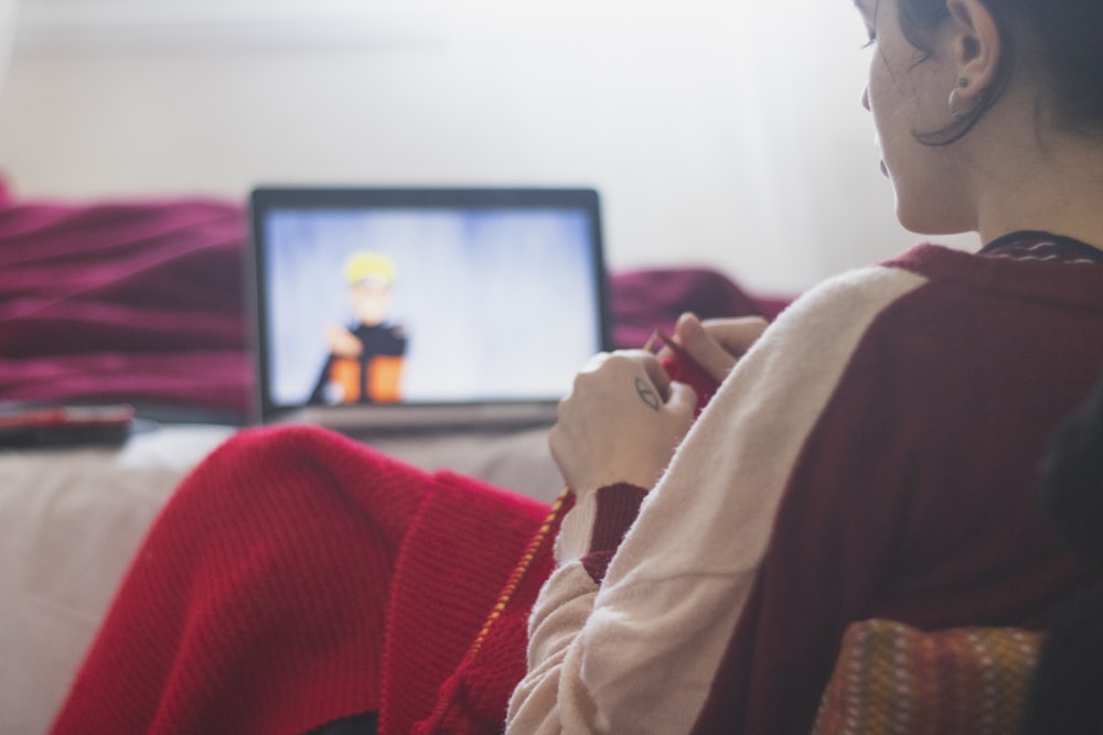 woman in red sweater sitting on chair