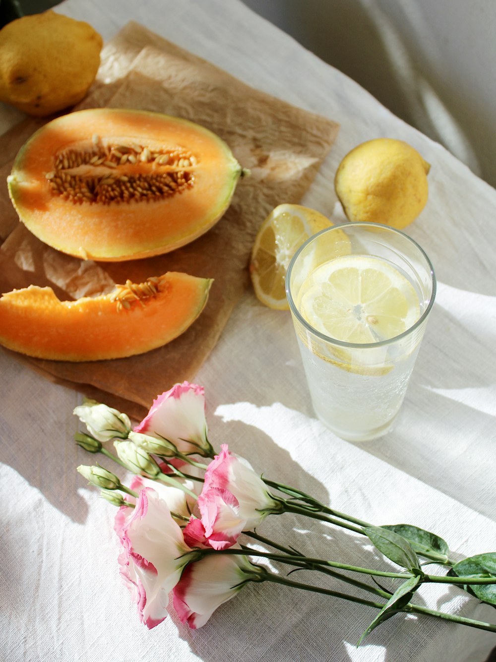 sliced orange fruit beside clear drinking glass